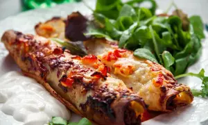 Två gyllene enchiladas med smält ost och en fräsch sallad. Perfekt för ett snabbt enchiladas recept.