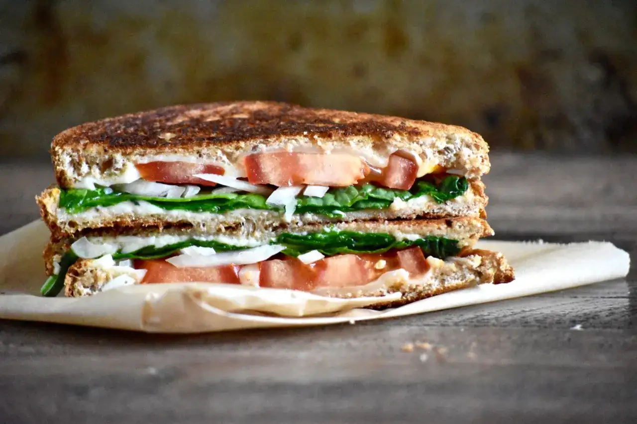 En dubbelmacka med fullkornsbr&ouml;d, f&auml;rsk spenat, tomat och l&ouml;k. Perfekt f&ouml;r nyttiga mackor till lunch eller mellanm&aring;l.