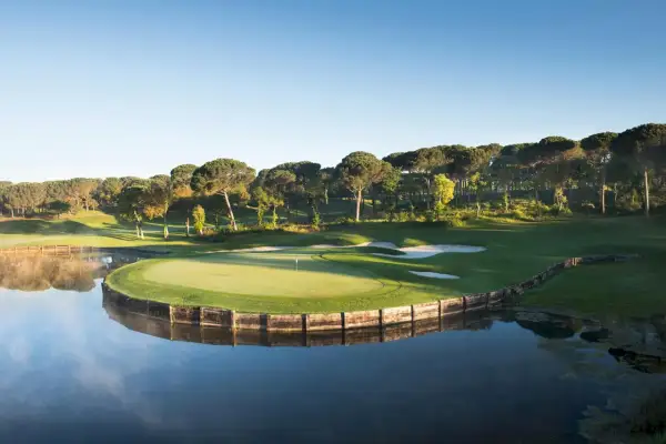 Vacker golfbana vid en sjö, perfekt för en golfhelg i Spanien.
